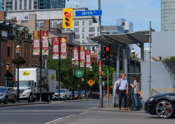 people at intersection of Front and Jarvis, waiting for light, 