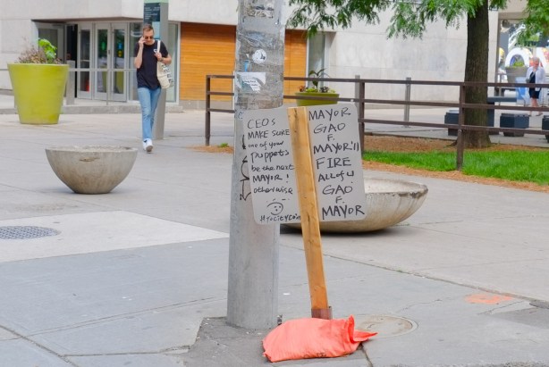 hand written sign posted in front of city hall