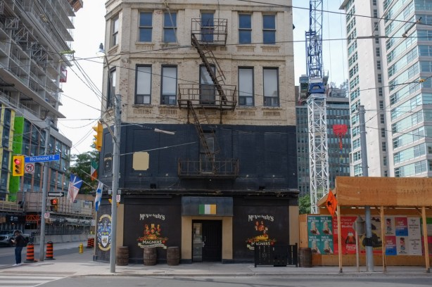 mcveighs irish pub in an old building at Richmond and church, now surrounded by new development