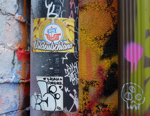 stickers on a pole, one says Noah forever, a small drawing of a skull