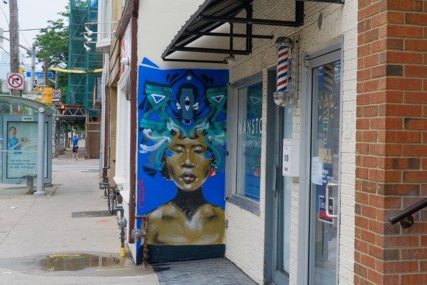 a small painting by Rowell, blue background, person head and shoulders, 