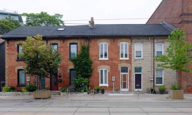 a row of two storey brick terrace houses, row houses, built in the 1880s, Queen St East in Toronto, 