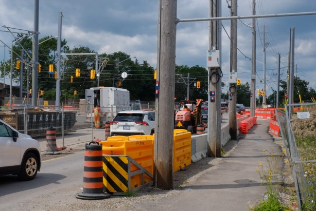 yellow and orange traffic barricades at construction site, finch avenue west