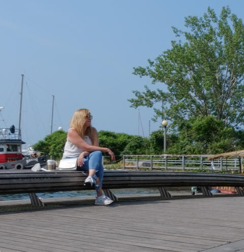 a woman site by herself on a bench