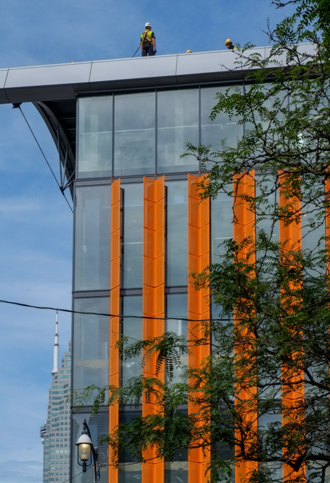 workmen on the roof of the new North tower of St. Lawrence market