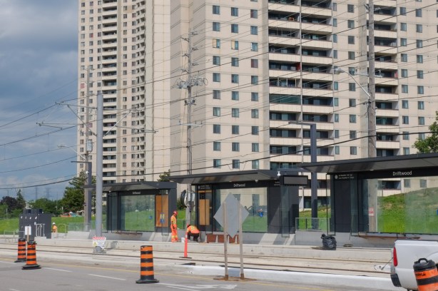 black structures as new lrt station on finch avenue, with apartment buildings behind