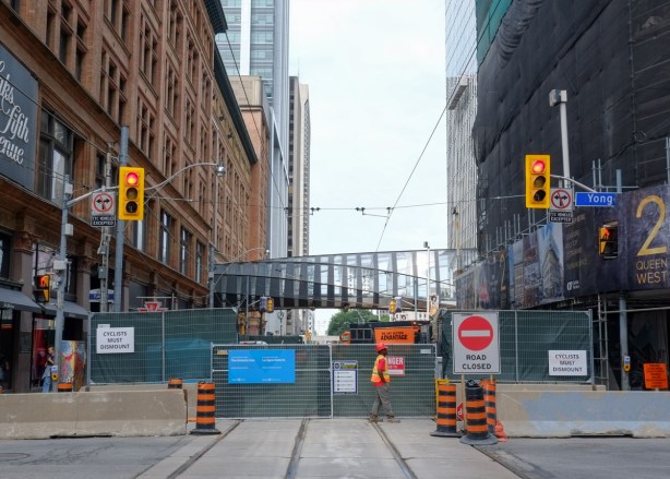 Looking west on Queen from Yonge, construction site, Queen street closure, glass tunnel over the street, road closed signs, 
