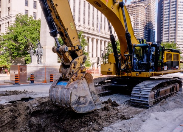 a digger, construction site, digging up street, University Ave