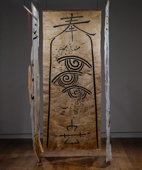 art installation including drawings and paintings on thin paper hung from the ceiling,