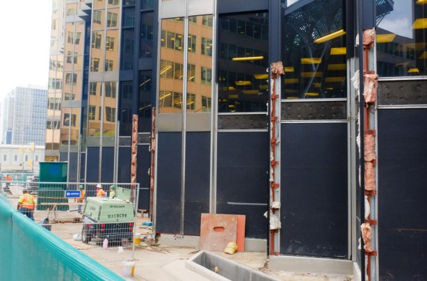 construction zone around the base of the royal bank building at bay and front, a gold tinted glass building