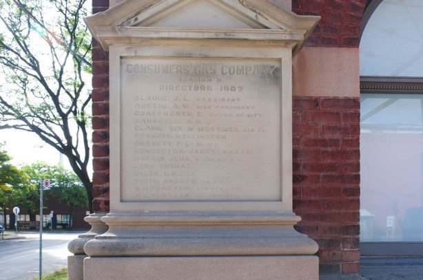 engraved stone with the list of Consumers Gas Company directors in 1907. on exterior of the building