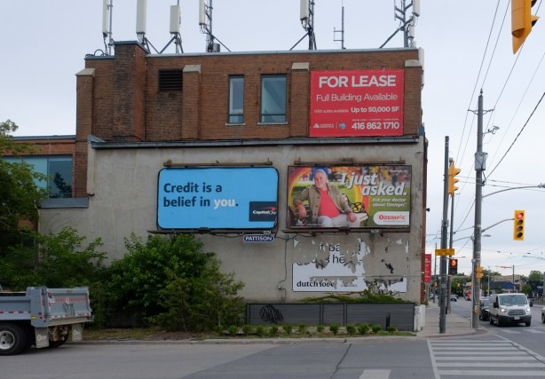 three storey industrial building with billboards on the side