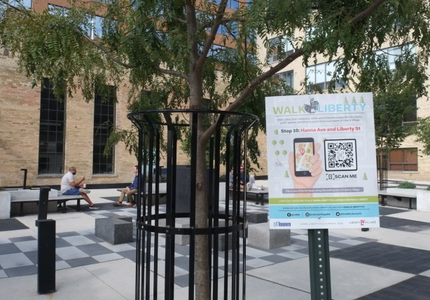 small public space in liberty village with sign posted red liberty village walks