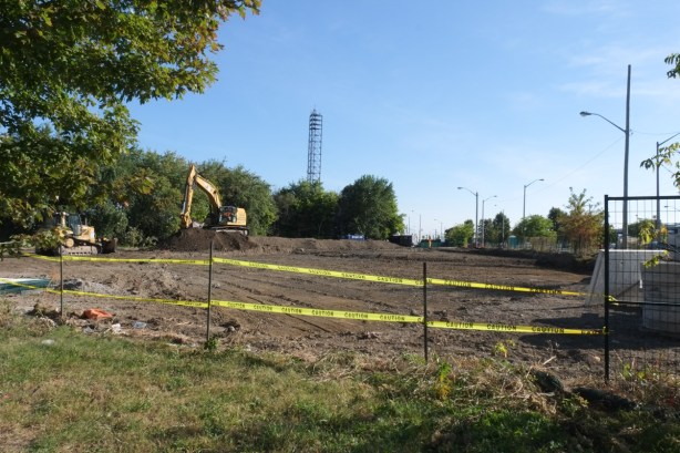levelled ground, dirt, construction equipment working there,