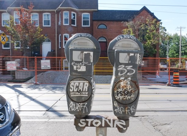 old grey metal parking meters, two on one stand