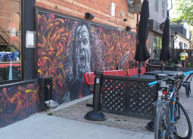 mural on wall beside sidewalk patio