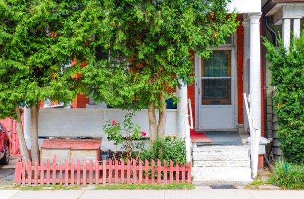 small red picket fence in front of a house