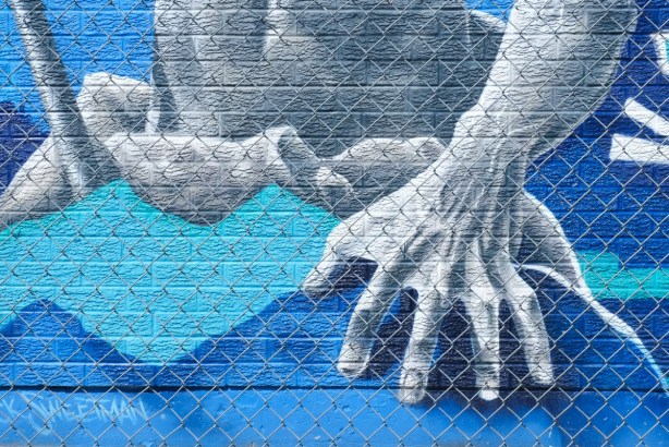 part of a mural, very large hand with webbed fingers, belonging to poseidon, greek god of the sea