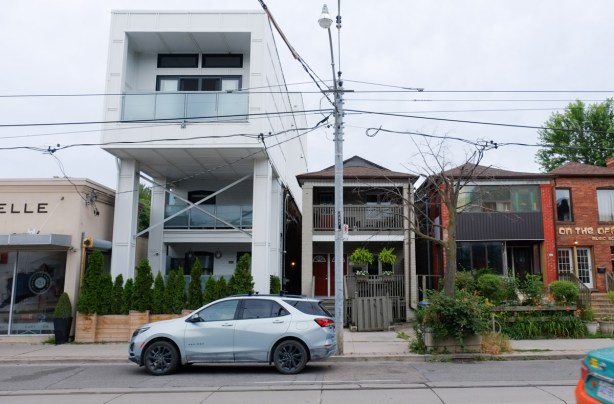 large third storey addition on a house, juts out over front yard