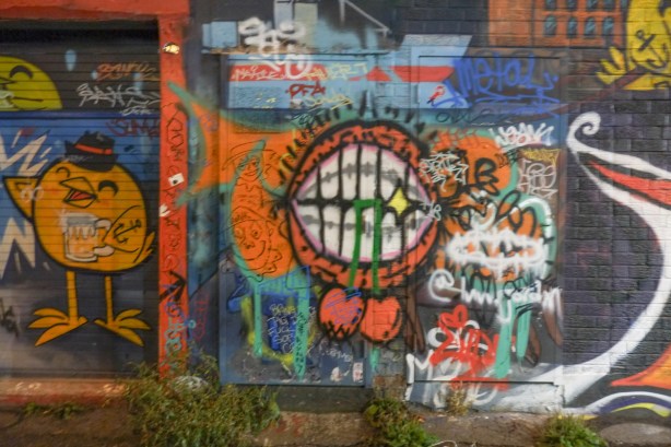 street art and graffiti on a wall in graffiti alley