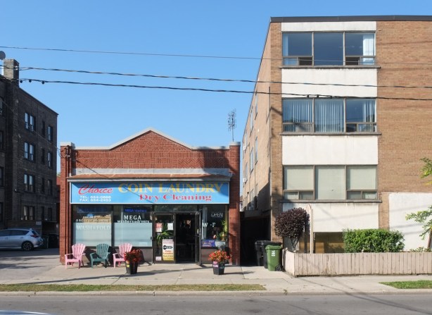 beside lowrise building from the 1960s, a single story older brick building, Choice coin laundry