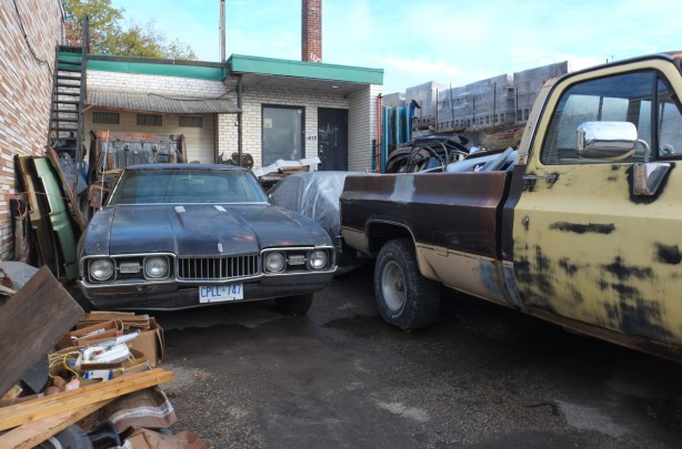 old cars and trucks outside house and mechanic workshop on dupont