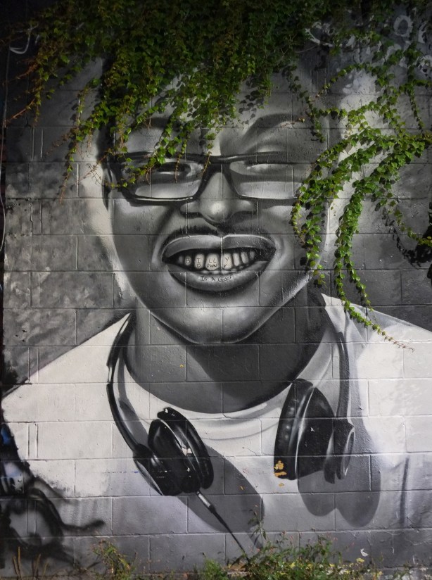 black and white portrait of a young man with glasses and headphones, 