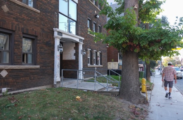front entrance of an older brick apartment building