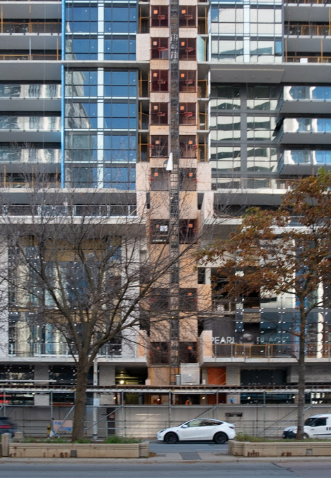 elevator on exterior of new highrise condo under construction on yonge street