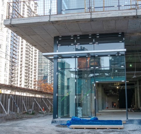 construction site, building of new entrance to new condo, lots of glass, open door, can inside the interior
