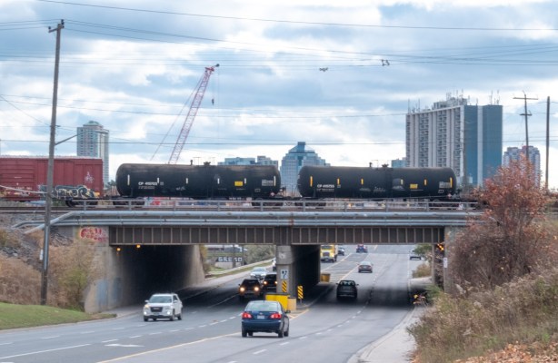 black tanker cars on railway bridge over McCowan