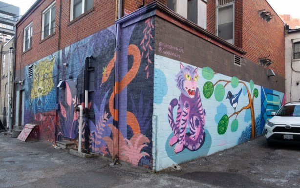 three murals on two sides of a building