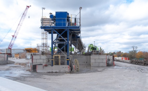 large blue piece of equipment on construction site, made for moving dirt that has been removed from tunnel by tunnel boring machine