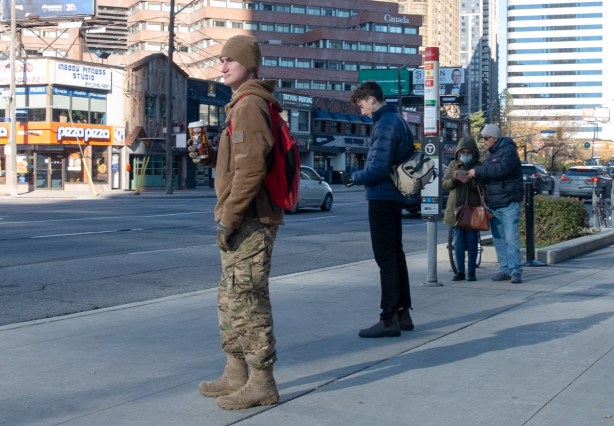 people waiting at a bus stop