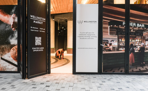 workman finishing floor details in wellington market, inside the well, getting ready to open new store