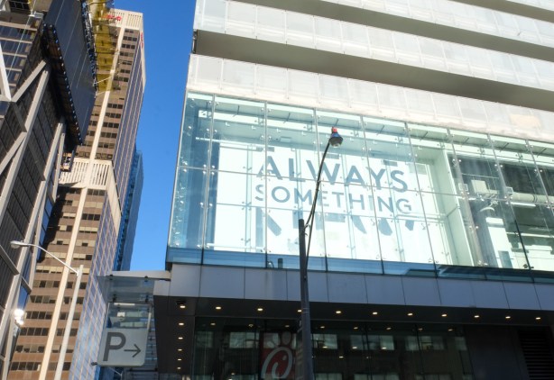 sign in an upper floor window that says always something new except the word new is worn out and parts are missing