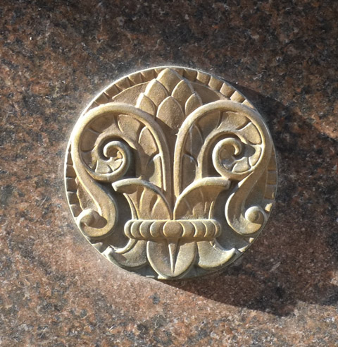 old round stone medallion on exterior of building