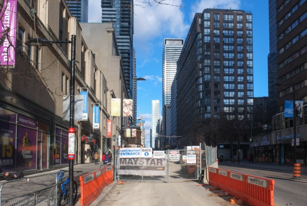 looking north on yonge from college, withone lane of traffic blocked because of construction 