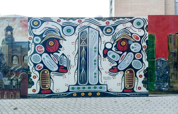 part of a mural about sherlock homes, a section by indigenous artist,