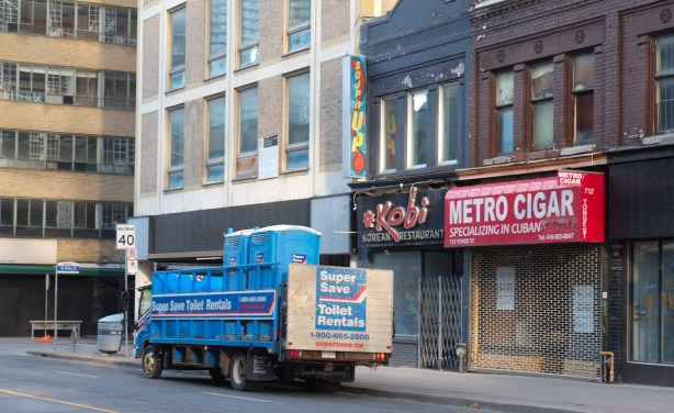 porta pottie truck parked in front of stores on yonge street