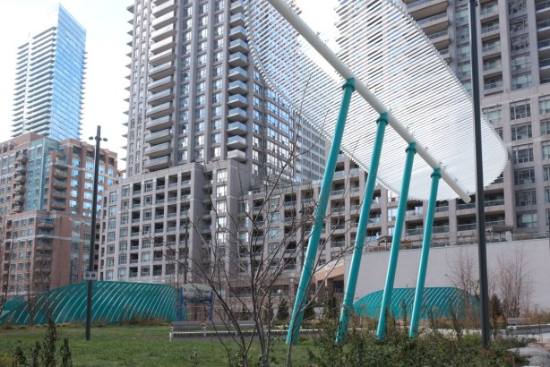 green supports on white sculpture in park