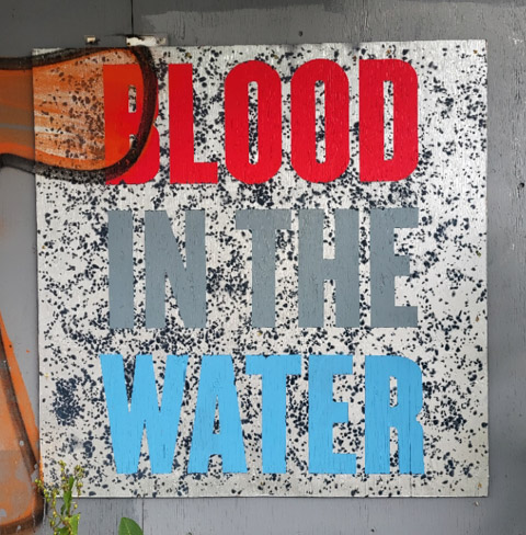 text on posters, graffiti, on empty buildings