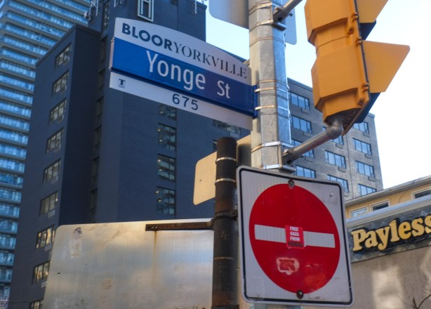 yonge street toronto street sign with upper part saying Bloor Yorkville, also red and white no entry sign with a sticker on it that says free palestine from hamas