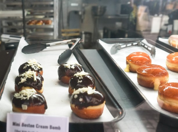 boston cream bomb donuts in the window of a donut store