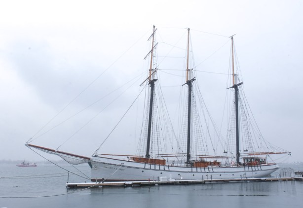 the Empire Sandy, a three masted sailing ship moored at a dock at Toronto Harbour, in winter, foggy grey day
