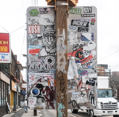 back of a traffic sign on dundas, completely covered with stickers