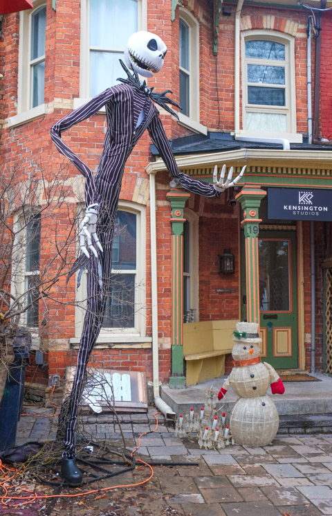 outside a house in Kensington, both halloween and christmas decorations, snowman