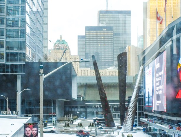 Maple leaf square view towards union station with royal york hotel in background, snowy, grey day, 