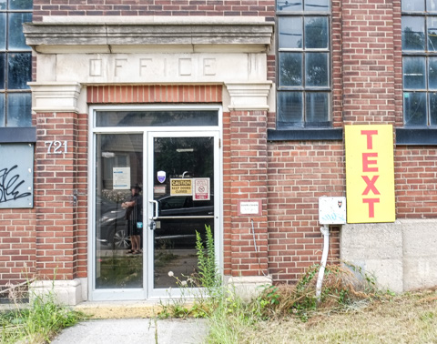 text on posters, graffiti, on empty buildings