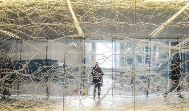 reflection in mirrored glass with a network of L E D lights running through it 